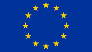 the European Union flag, a circle of gold stars on a navy blue background