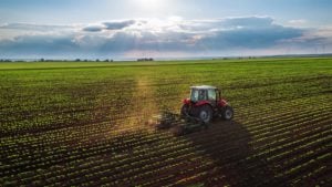 Image of a tractor cultivating field