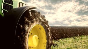 a tractor tire pictured in a field on the tractor