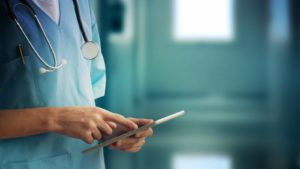 SAVA stock a doctor looks at a tablet