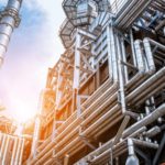 Factory pipes and towers at sunset