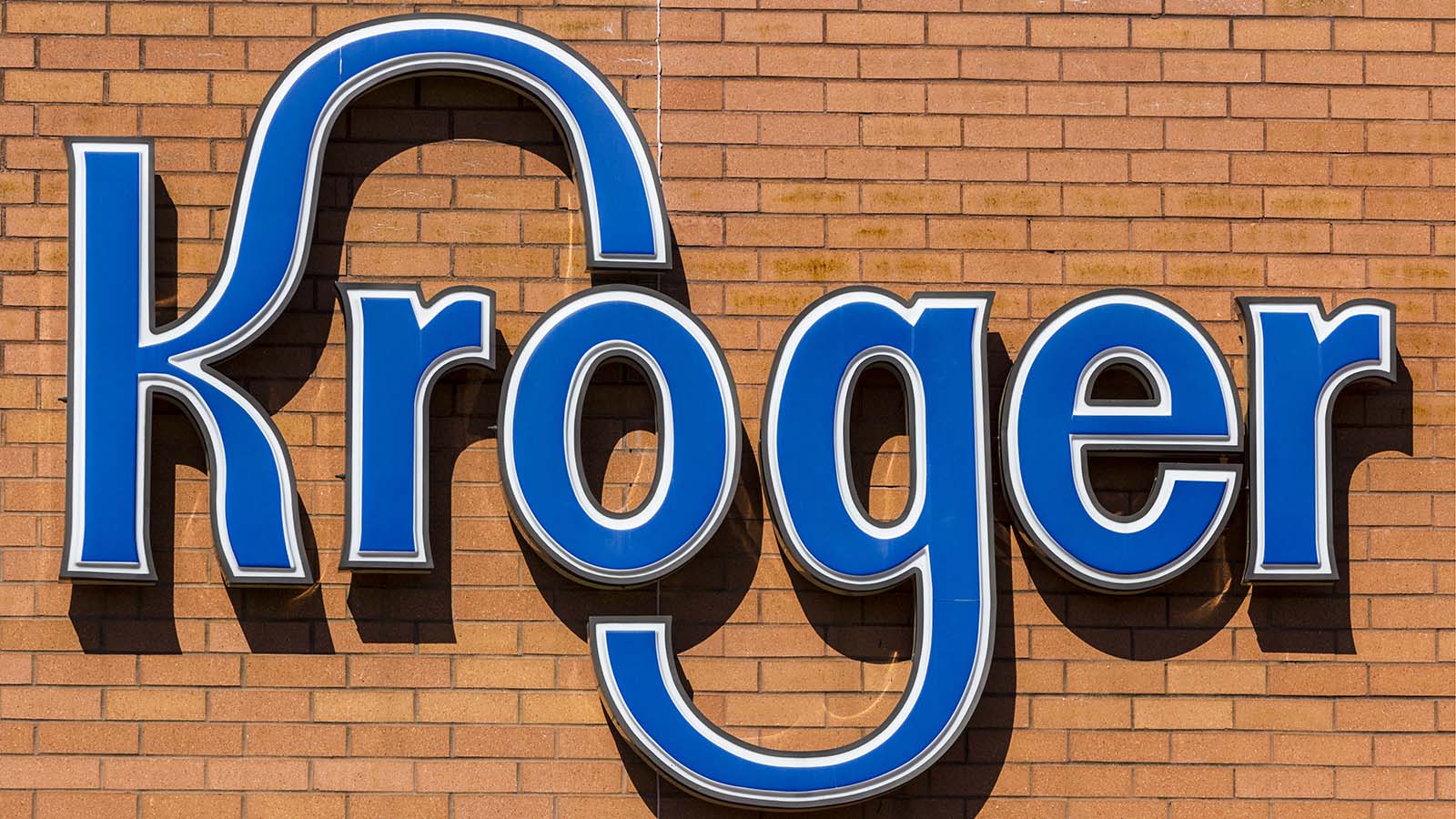A Kroger (KR Stock) logo on a building.