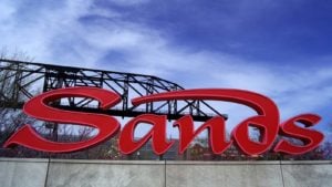 a red sign with the Las Vegas Sands logo entertainment stocks