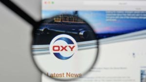 A magnifying glass zooms in on the Occidental Petroleum (OXY stock) website.