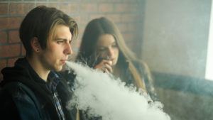 Two people using a vape representing Vaping Stocks.