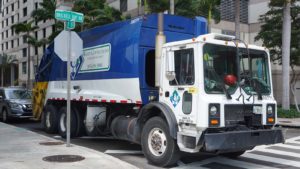 WCN stock: a garbage truck parked at a curb