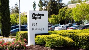 A photo of a Western Digital Corp (WDC) sign outside a building and parking lot.
