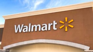 Image of Walmart (WMT) logo on Walmart store with clear blue sky in the background