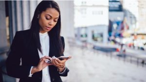 Image of a black woman on her smartphone.