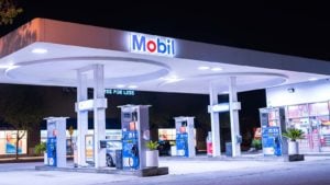 A view of a well-lit Exxon Mobil (XOM) gas station in Pasadena, CA during nighttime. representing exxon mobil stock