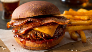a bacon cheeseburger representing restaurant stocks