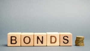 Wooden blocks with the word Bonds and coins.