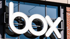 Image of the Box (BOX stock) logo in front of a glass window on a brick building