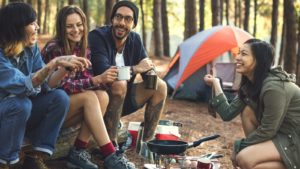 a couple have breakfast at a campsite