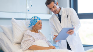 image of a doctor showing a patient a chart representing CRSP stock.
