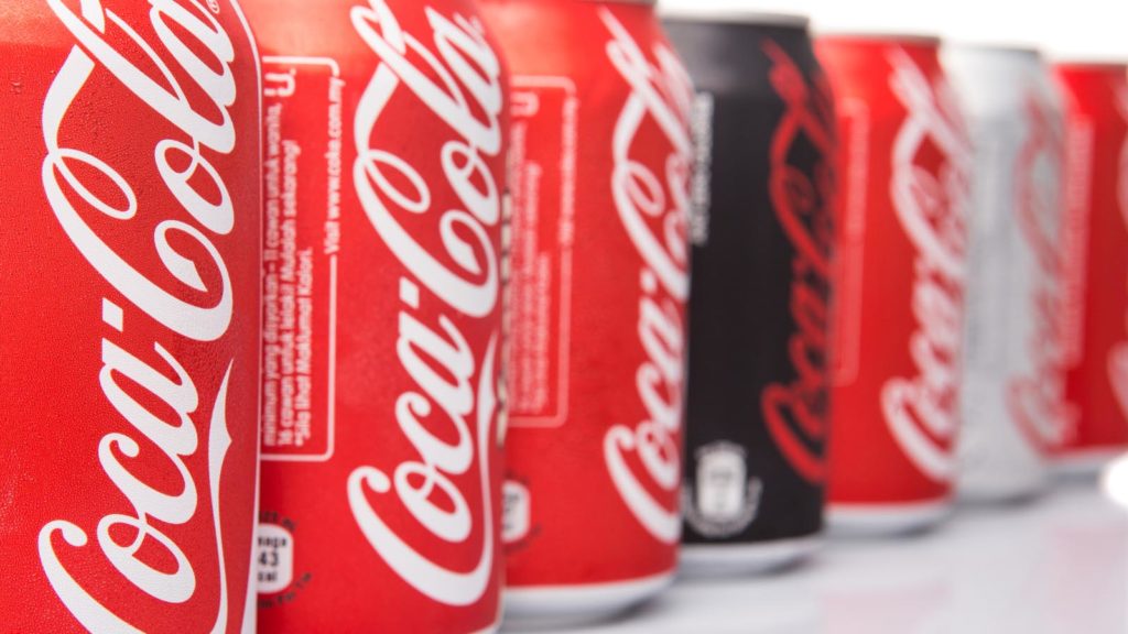 a line of Coca-Cola (KO) cans