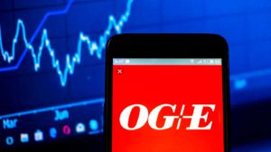 OGE Energy stock on a phone with a blue background