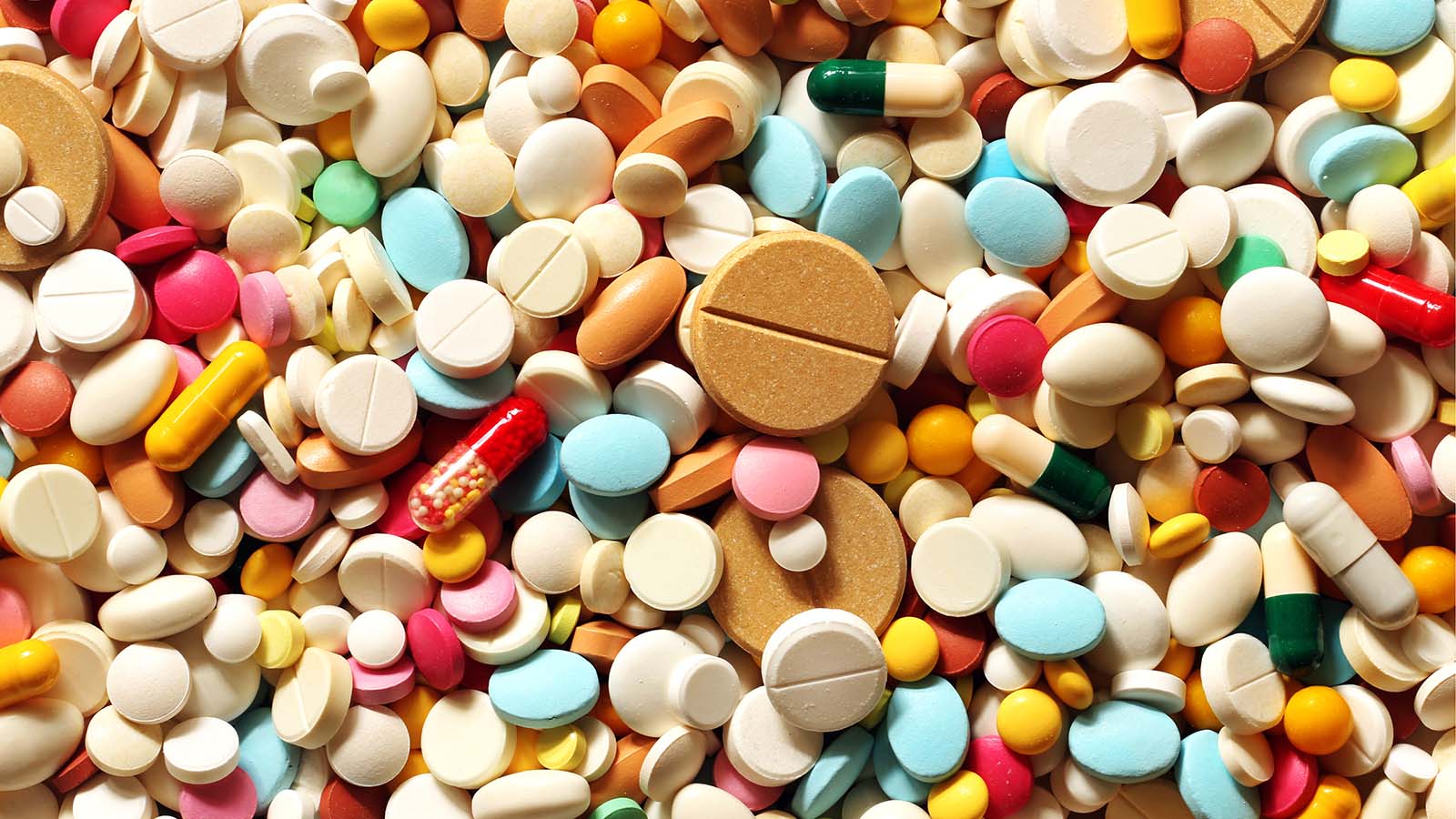 A pile of brightly colored pills in varying sizes and shapes representing DAWN Stock.
