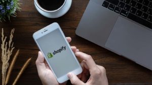 Shopify (SHOP) logo on an app on someone's smartphone.