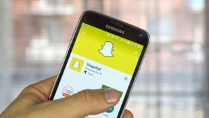 Snapchat (SNAP) application on android cell smartphone. Snapchat is a mobile messaging application used to share photos, videos, text, and drawings.