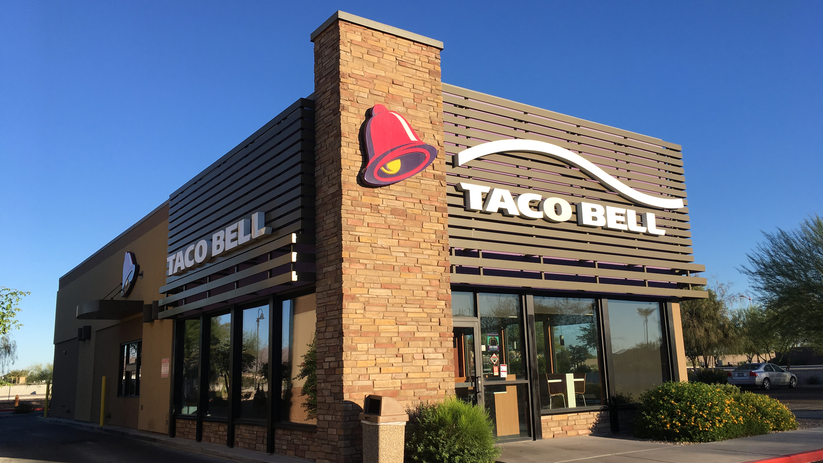 The close-up of a Taco Bell (YUM Stock) store with logo on the front representing Taco Bell Mexican Pizza Shortage