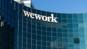 Image of WeWork logo on the side of a glass building.