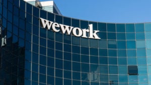 Image of WeWork logo on the side of a glass building.