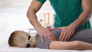 a chiropractor works on a woman's back