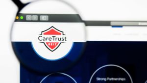 a magnifying glass enlarges the CareTrust logo on a website