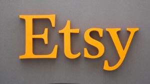 etsy logo on a grey wall representing the company's stock.