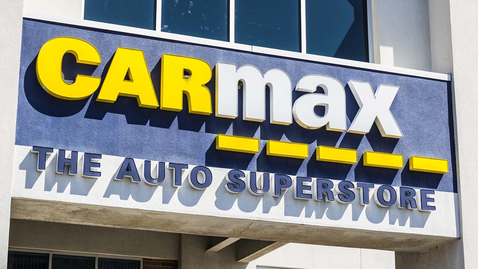 a Carmax (KMX) sign on a storefront