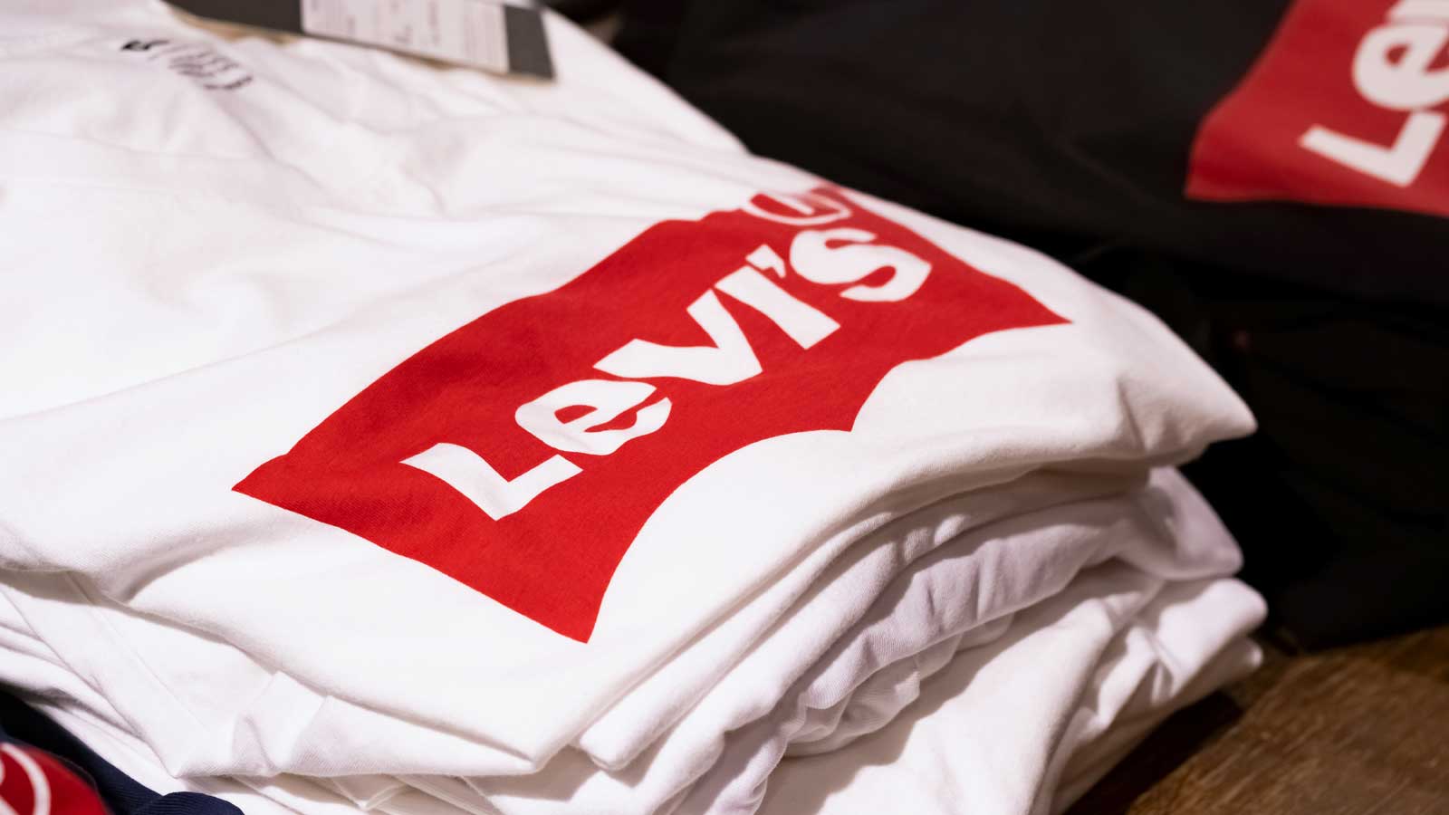 a stack of white t-shirts with the Levi's (LEVI) logo on them