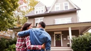 A man and woman looking at their new house.