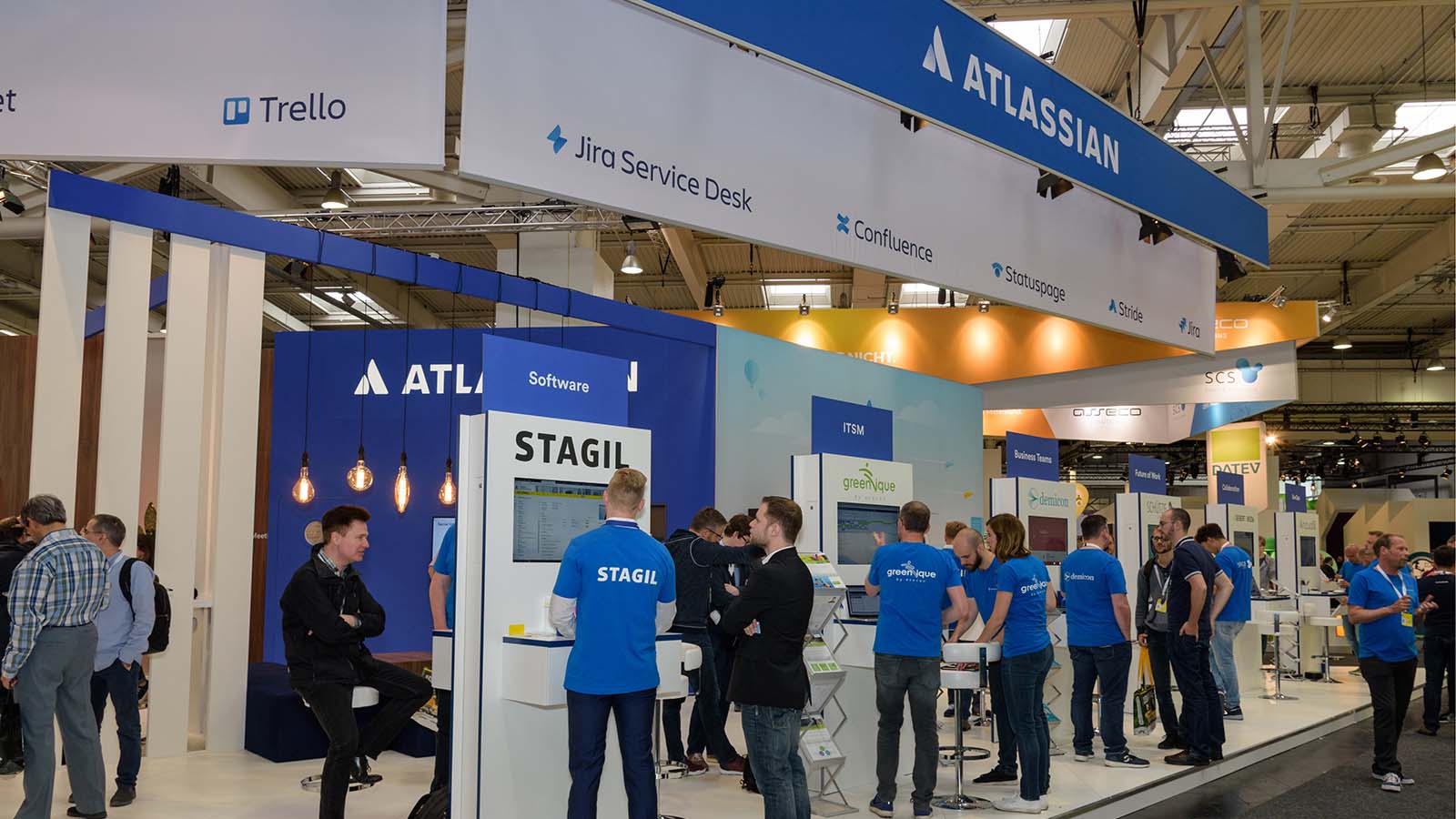Atlassian (TEAM) employees stand at a booth in Hanover, Germany.