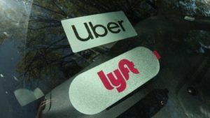 The UBER and LYFT logos representing the stocks of each company.