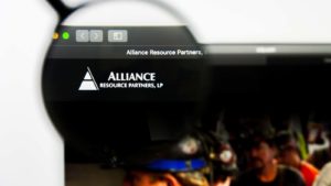 A magnifying glass zooms in on the logo for Alliance Resource Partners, L.P. (ARLP)