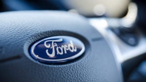 Ford (F Stock) logo on a steering wheel.