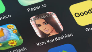 The logo for the Kim Kardashian game from Glu Mobile (GLUU) is displayed on a smartphone screen.
