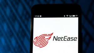 netease (NTES) logo on a mobile phone screen representing earnings reports. best investments to start 2021