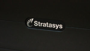 Stratasys (SSYS) logo on a black background