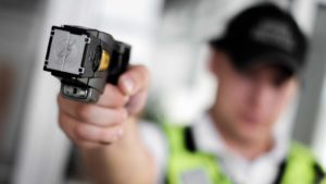a police officer holding a taser in his hand