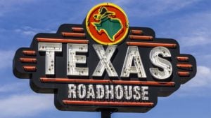 An outside and closeup view of a Texas Roadhouse, Inc. (TXRH) sign