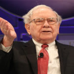 Warren Buffett gestures to an audience. Warren Buffett stocks to buy