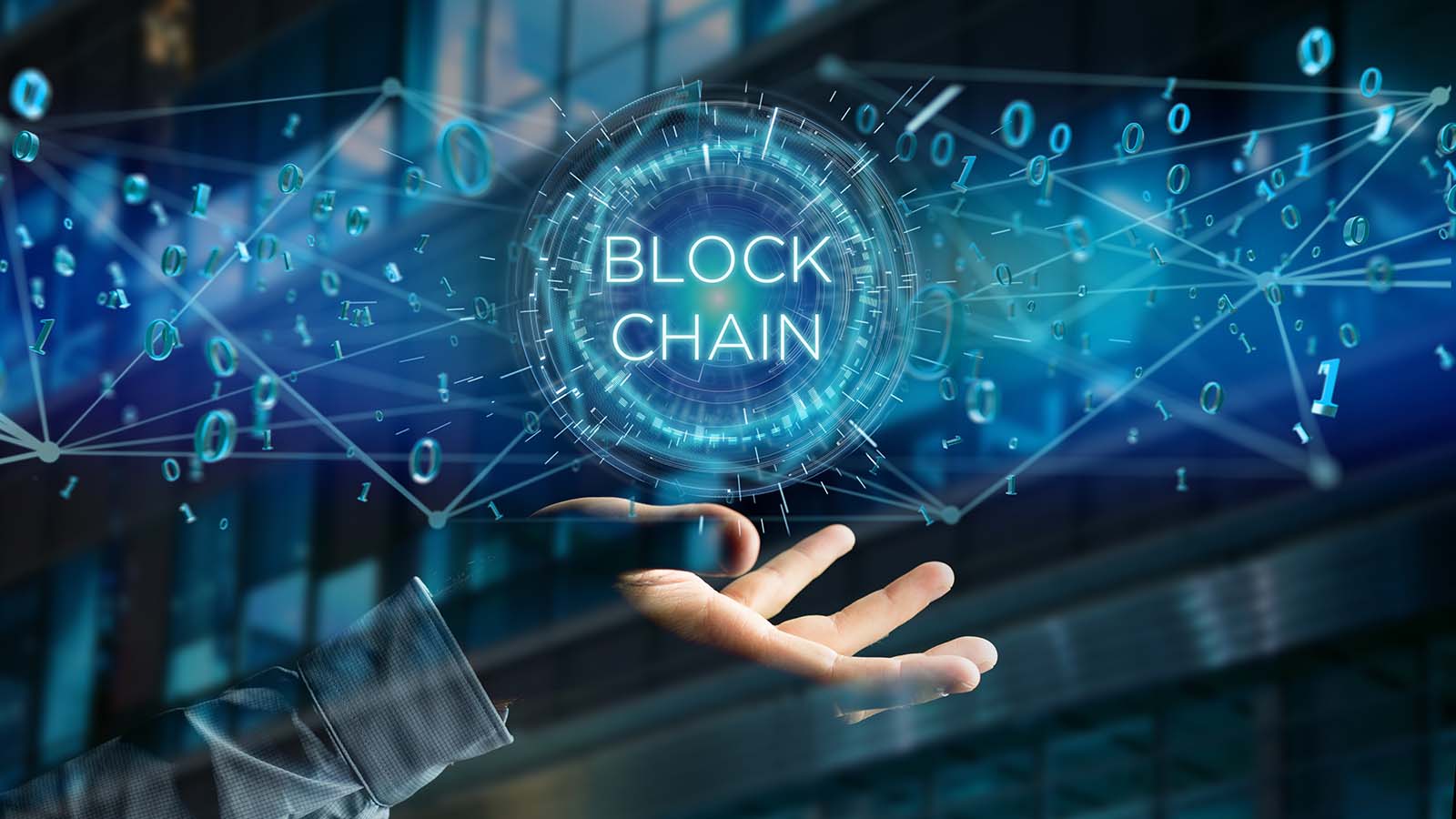 futuristic image of a hand with the words block chain floating above it. representing riot blockchain stocks