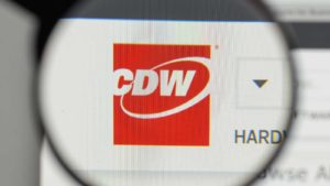 A magnifying glass zooms in on the CDW Corporation (CDW) logo