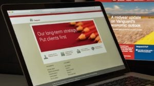 The Vanguard website is displayed on a laptop screen. vanguard etfs