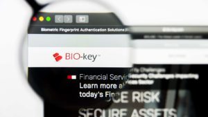 the biokey (bkyi) logo on a web page under a magnifying glass
