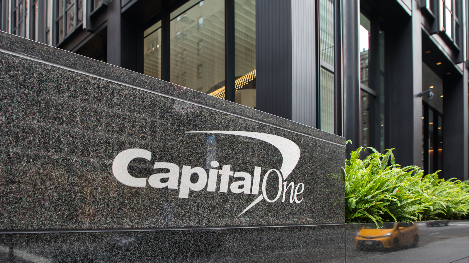 capital one layoffs (COF stock) logo outside of corporate building