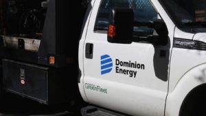 A side view of a Dominion Energy (D) pick-up truck.