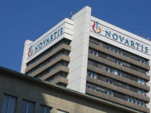 A photo of a large building with a Novartis sign on it